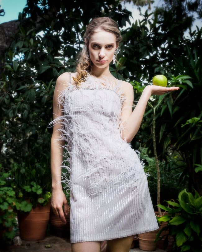 feathers wedding dress woman holding green apple